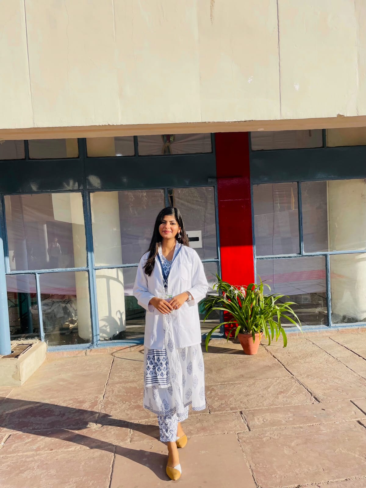 Dt. Kritika Lodha in a white coat outside the Postgraduate Institute of Medical Education and Research, Chandigarh